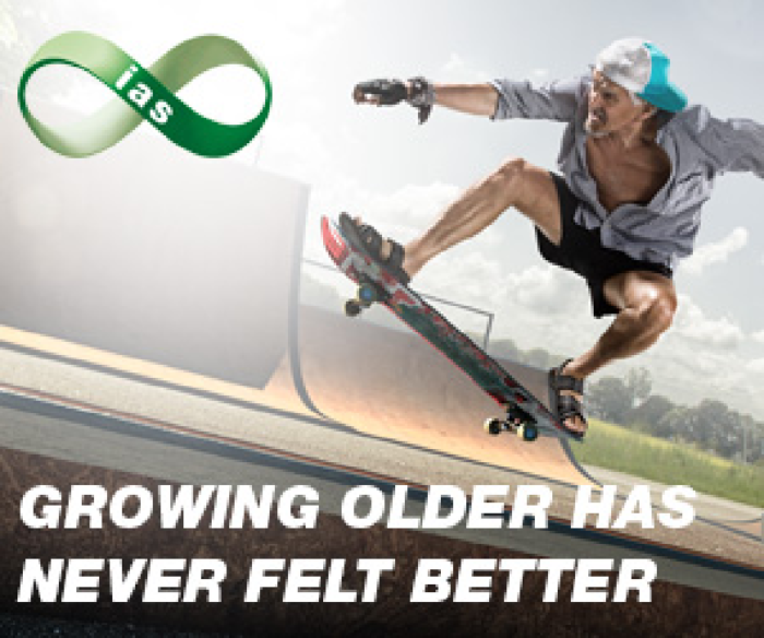Elderly man jumping on a skateboard a skate park