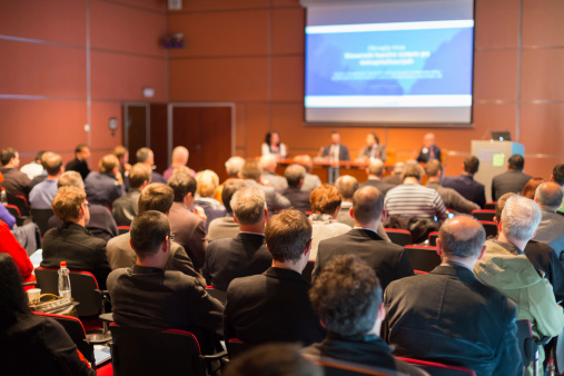 A hall full of people at a work conference